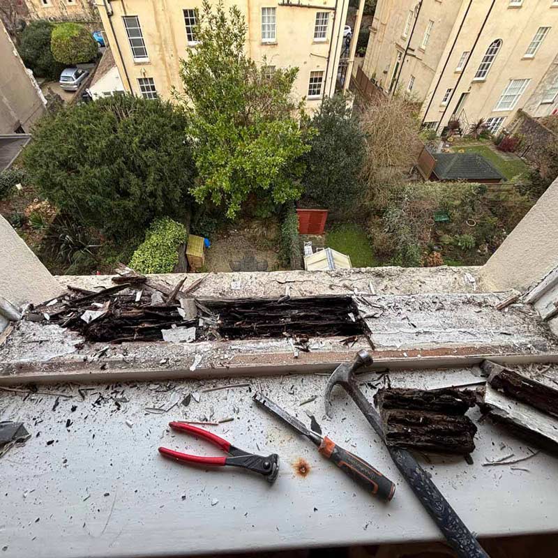 Rotted timber sash window sill exposed during repair work in a Clevedon property