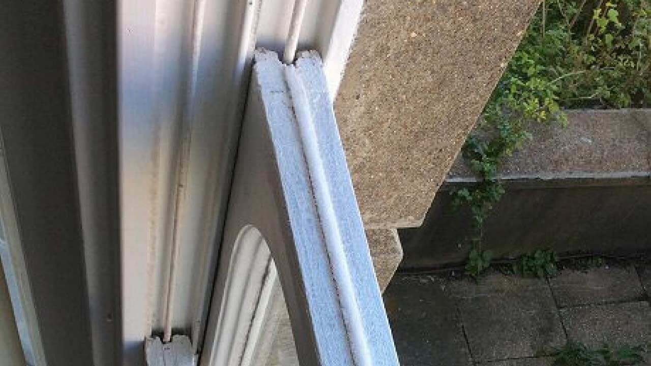 Close view of brush pile draught proofing seal fitted into a timber sash window